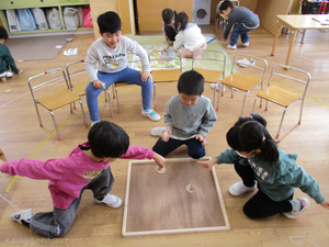 写真:コマを回して友達と競っているところ